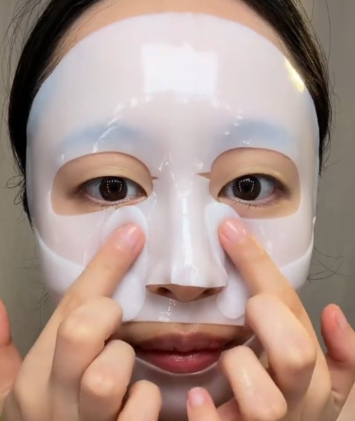 Ajustement du masque hydrogel Biodance autour du nez et des joues.
